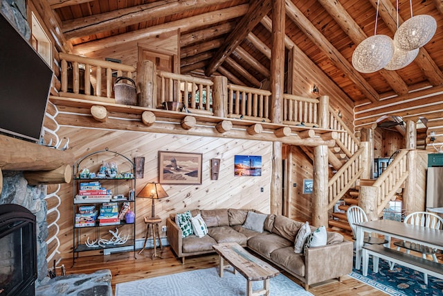 living room with wooden ceiling, hardwood / wood-style floors, wooden walls, and beamed ceiling