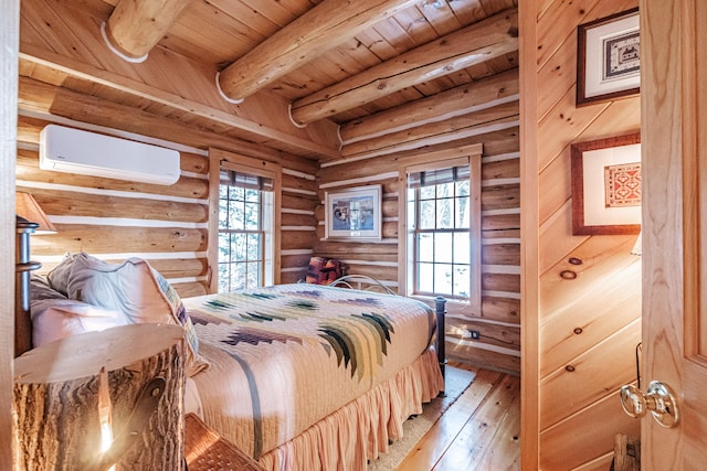 bedroom featuring a wall mounted AC, light hardwood / wood-style floors, wooden ceiling, rustic walls, and beam ceiling