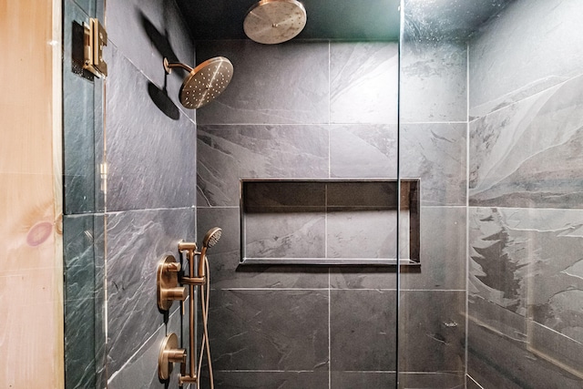 bathroom with a tile shower