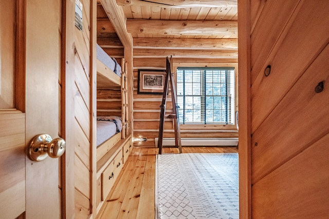 interior space with baseboard heating, wood ceiling, wood walls, light hardwood / wood-style flooring, and beam ceiling