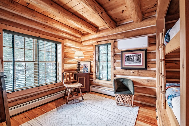 sitting room with light hardwood / wood-style floors, a baseboard radiator, rustic walls, beam ceiling, and an AC wall unit