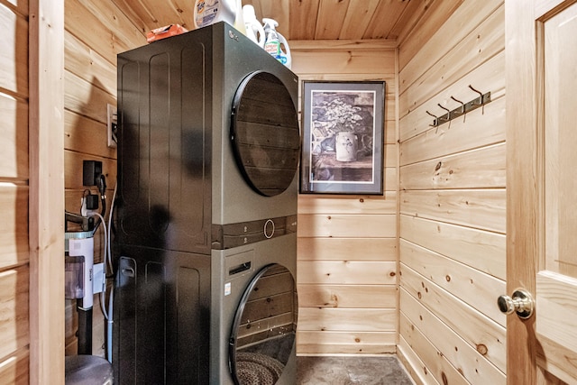 laundry room featuring wood ceiling, stacked washer and dryer, and wooden walls