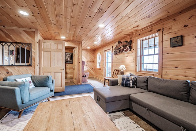 living room featuring light hardwood / wood-style floors, wooden ceiling, and wood walls