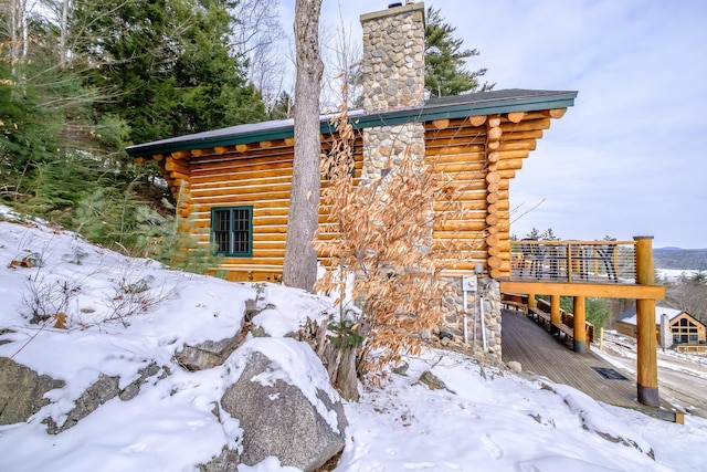 view of snow covered exterior featuring a deck