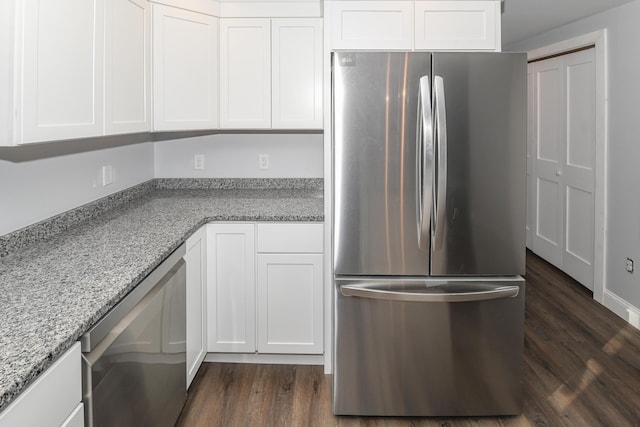 kitchen featuring white cabinetry, appliances with stainless steel finishes, dark hardwood / wood-style flooring, and light stone countertops