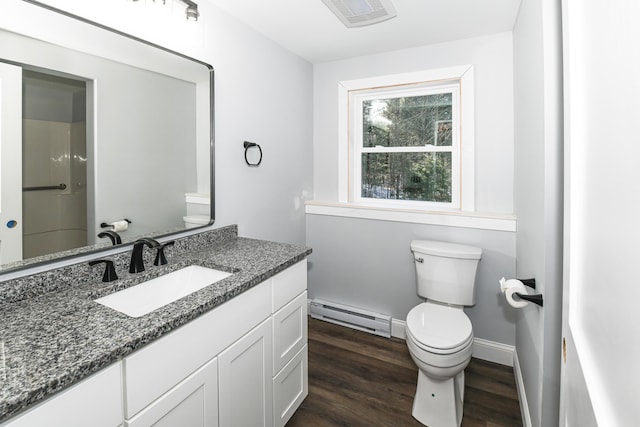 bathroom with vanity, hardwood / wood-style flooring, a baseboard radiator, and toilet