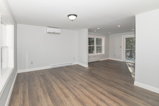 unfurnished room with a baseboard radiator, an AC wall unit, and dark hardwood / wood-style floors