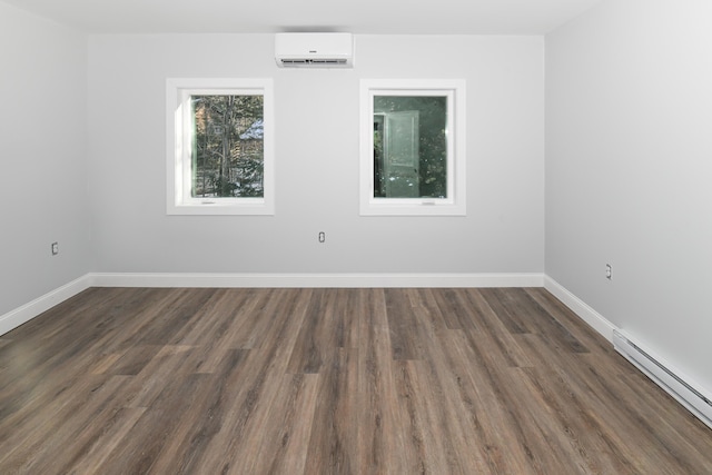 empty room featuring dark wood-type flooring, a baseboard radiator, and a wall mounted AC