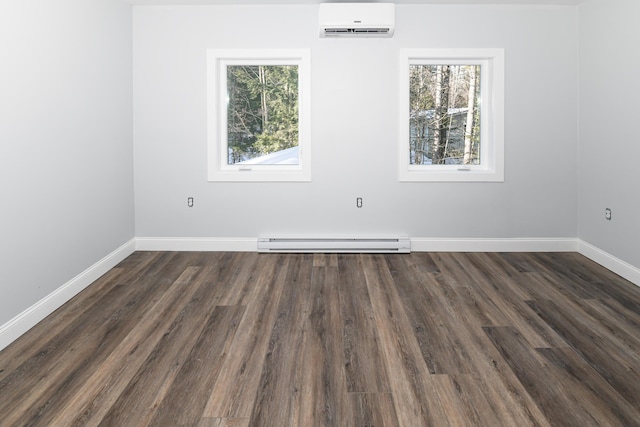 spare room featuring baseboard heating, a wall mounted air conditioner, and dark hardwood / wood-style flooring