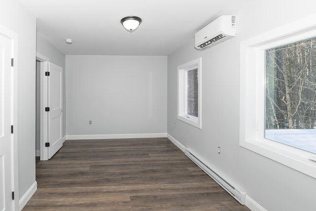 empty room with a baseboard heating unit, dark hardwood / wood-style floors, an AC wall unit, and a healthy amount of sunlight