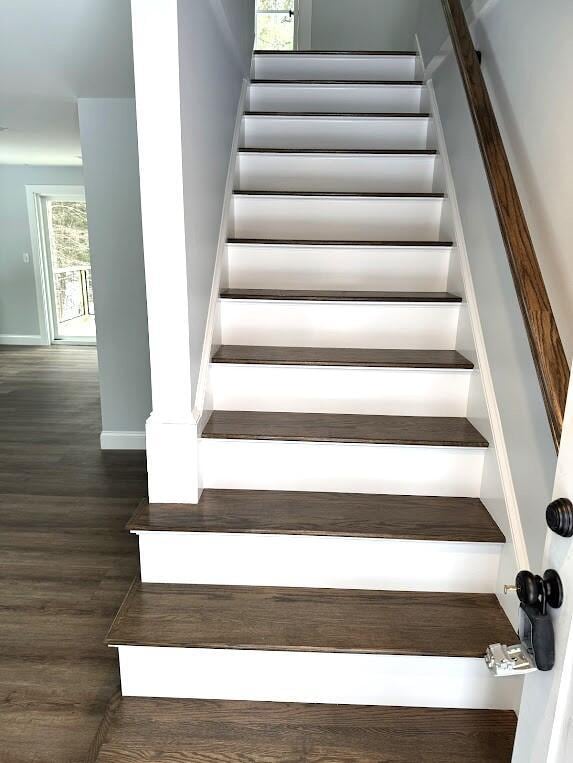 staircase with hardwood / wood-style flooring