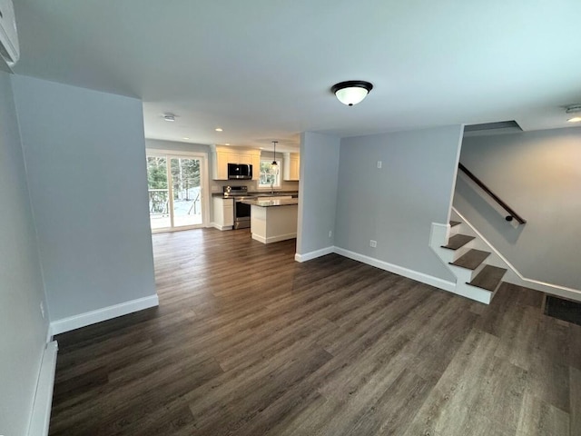 unfurnished living room with dark hardwood / wood-style floors