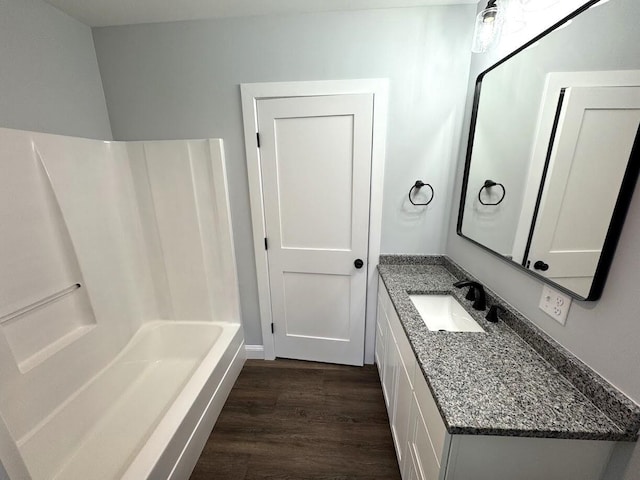 bathroom with vanity, shower / washtub combination, and hardwood / wood-style floors