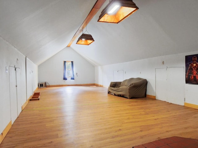 additional living space featuring light hardwood / wood-style flooring and lofted ceiling