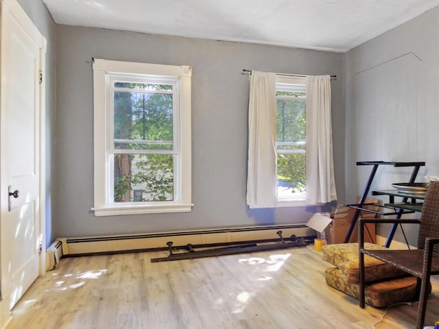 interior space with baseboard heating and hardwood / wood-style floors