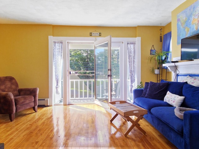 living room with wood-type flooring and a baseboard radiator