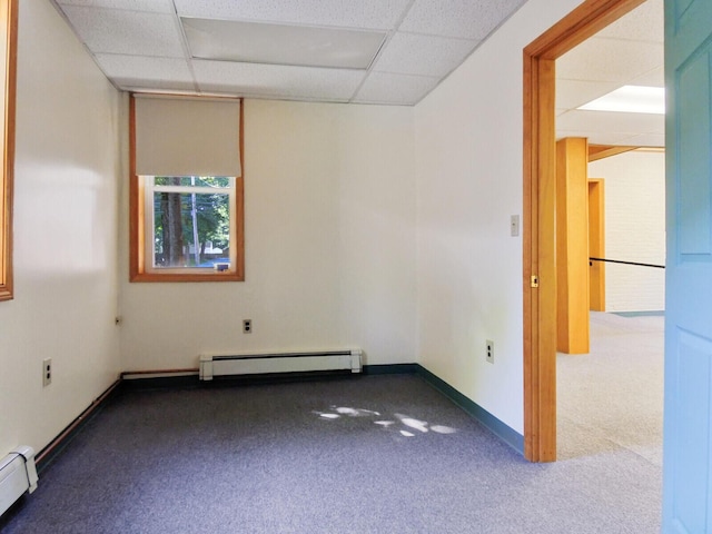 spare room featuring carpet, a paneled ceiling, and baseboard heating