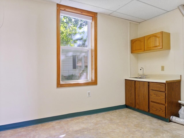 kitchen featuring a paneled ceiling and sink