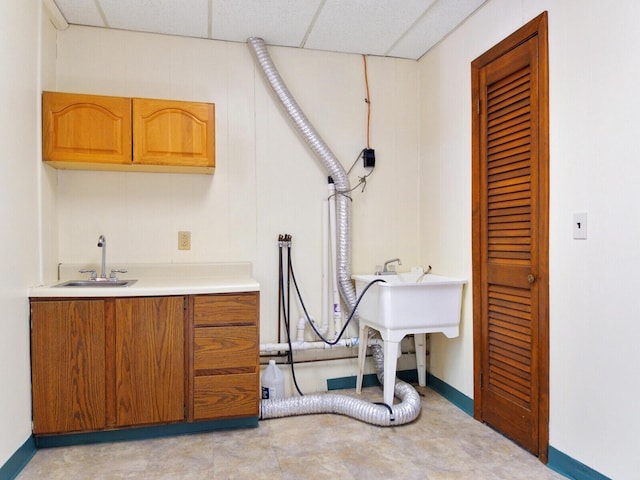 laundry room featuring cabinets and sink