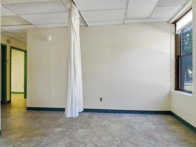 spare room with a paneled ceiling