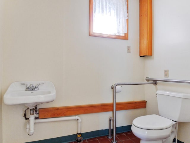 bathroom with toilet and tile patterned flooring