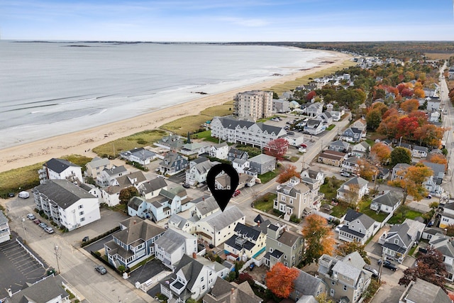 drone / aerial view featuring a water view and a view of the beach