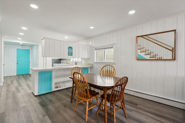 dining space with dark wood-type flooring and a baseboard radiator