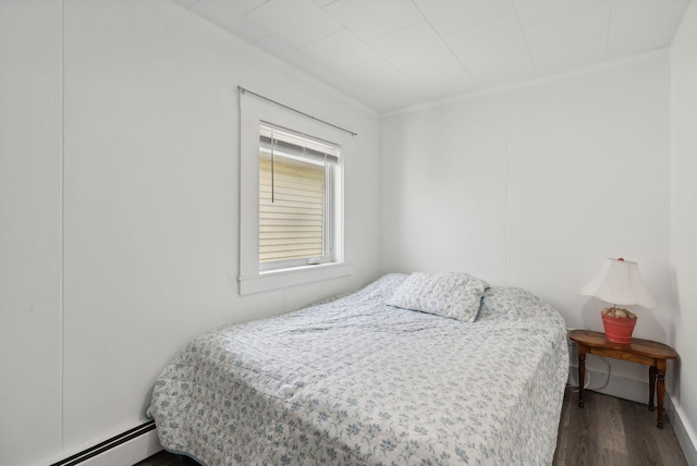 bedroom with hardwood / wood-style flooring and a baseboard radiator