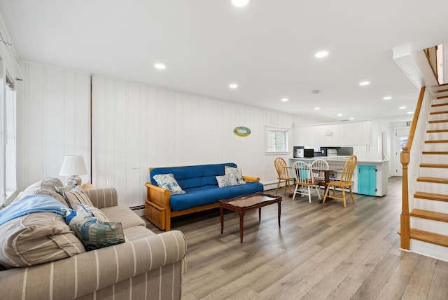 living room featuring baseboard heating and light hardwood / wood-style floors