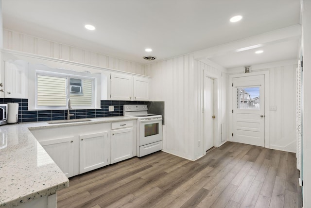 kitchen featuring white cabinetry, white range with electric cooktop, decorative backsplash, sink, and light stone counters