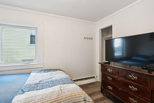 bedroom featuring a baseboard radiator, dark hardwood / wood-style flooring, and crown molding