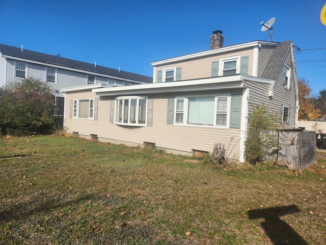 rear view of house with a yard