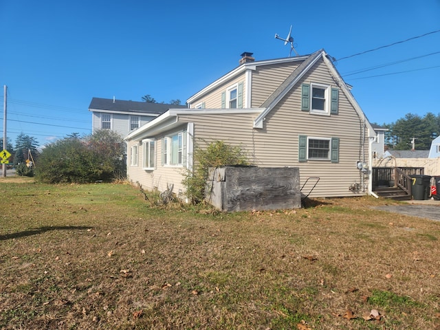 view of side of home with a lawn