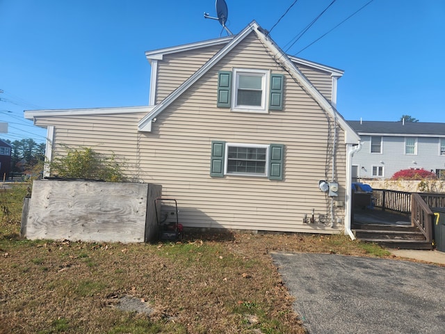 view of side of home featuring a wooden deck