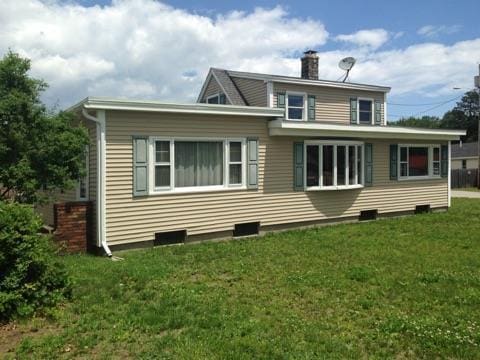 rear view of house with a lawn