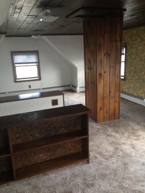 bonus room with a baseboard radiator, light colored carpet, wooden ceiling, and vaulted ceiling