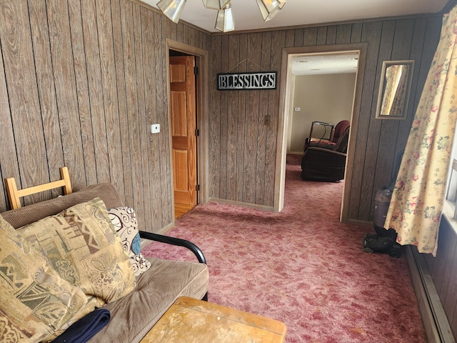 living area featuring carpet flooring and wood walls