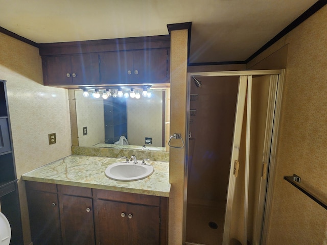 bathroom featuring an enclosed shower and vanity