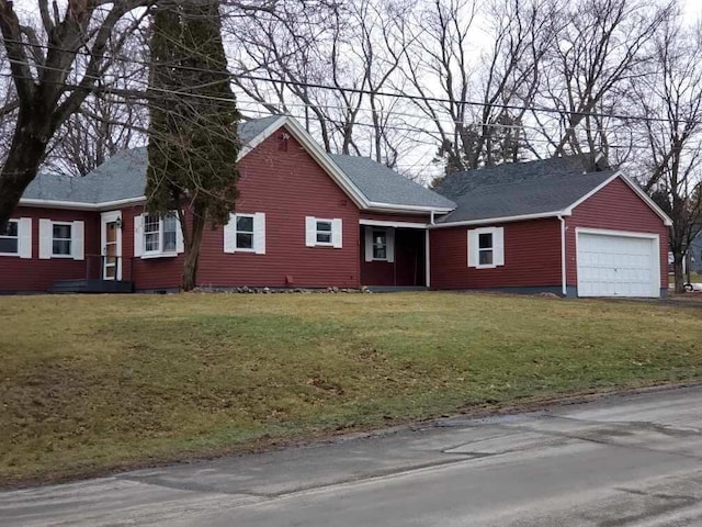 view of front of home with a front lawn and a detached garage