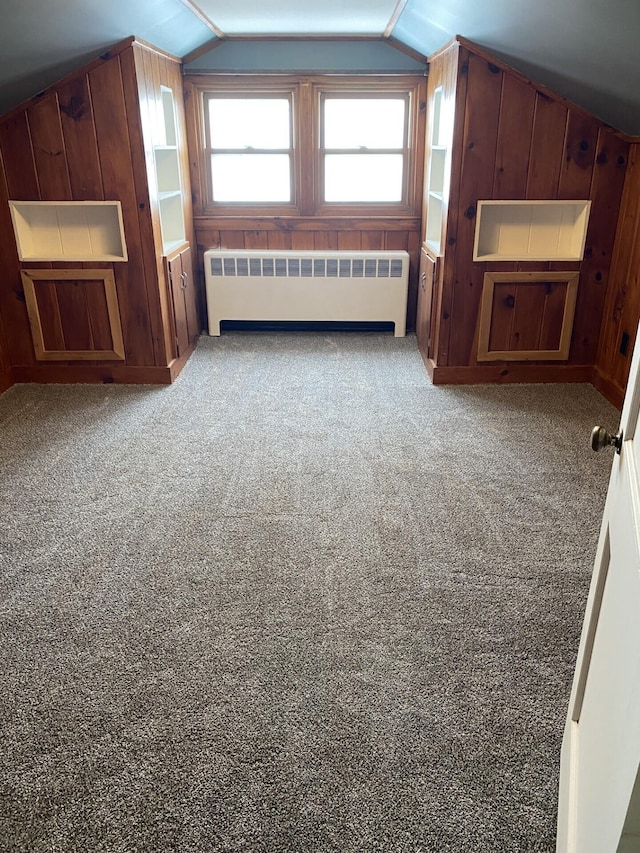 additional living space with vaulted ceiling, plenty of natural light, and radiator