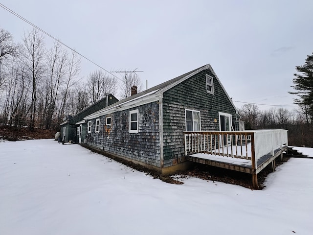 snow covered property featuring a wooden deck