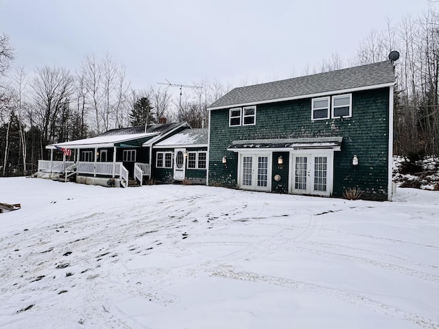 snow covered property featuring french doors