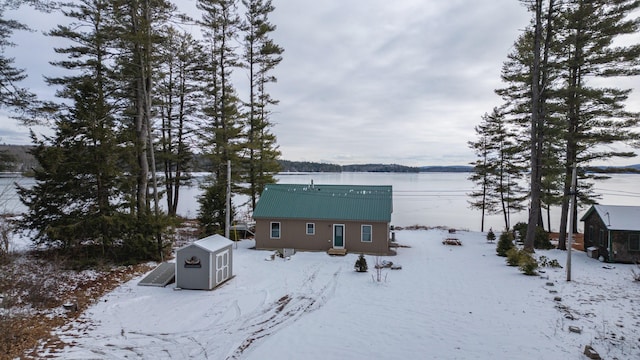 exterior space with a water view and a shed