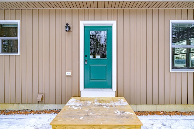 view of snow covered property entrance