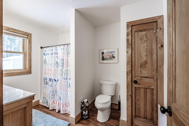 bathroom featuring toilet, vanity, and hardwood / wood-style floors