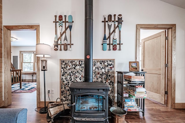 details with hardwood / wood-style flooring and a wood stove