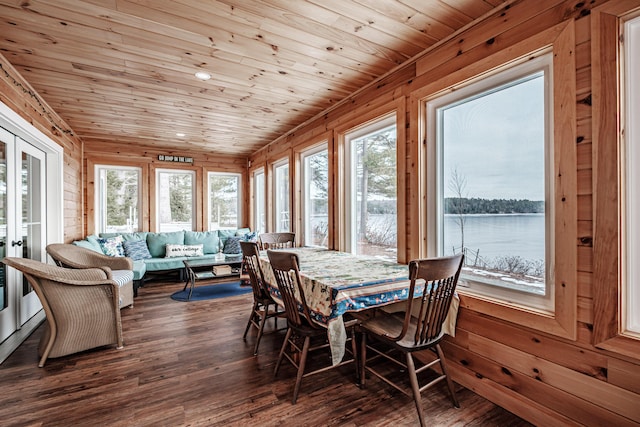 sunroom / solarium featuring wooden ceiling, a water view, and french doors