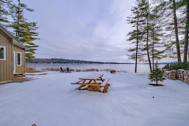 snowy yard with a water view