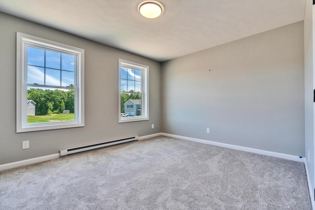 unfurnished room featuring baseboard heating and carpet