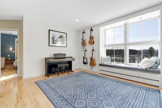 sitting room with baseboard heating and light wood-type flooring